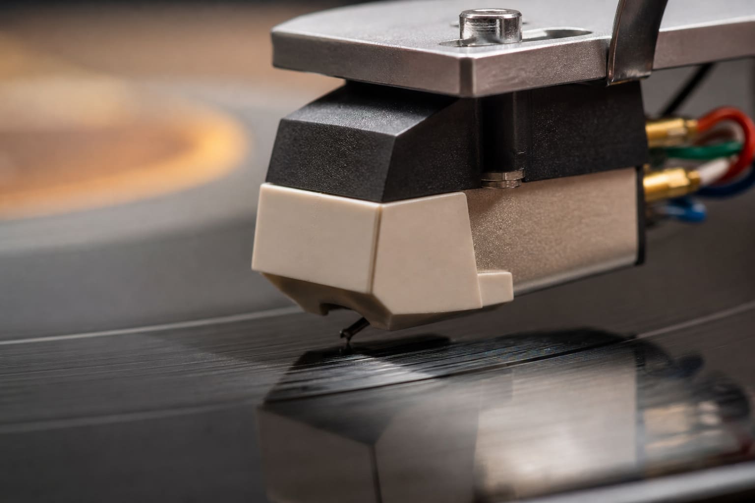 Close-up of a turntable needle on a vinyl groove
